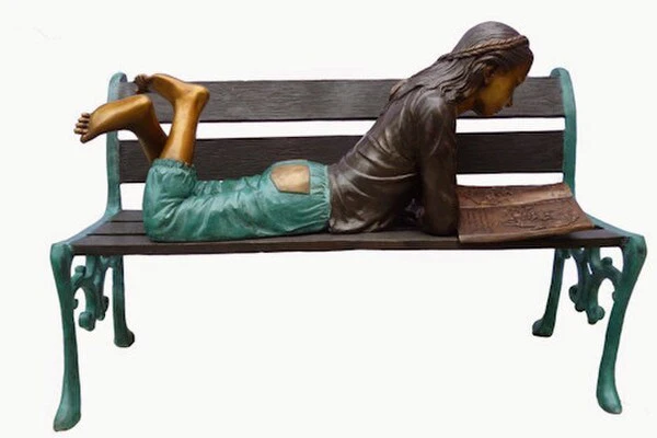 Bronze Girl Lying on Park Bench Reading Statue - Image 2