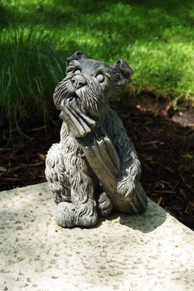 Dog Chewing on News Paper Statue
